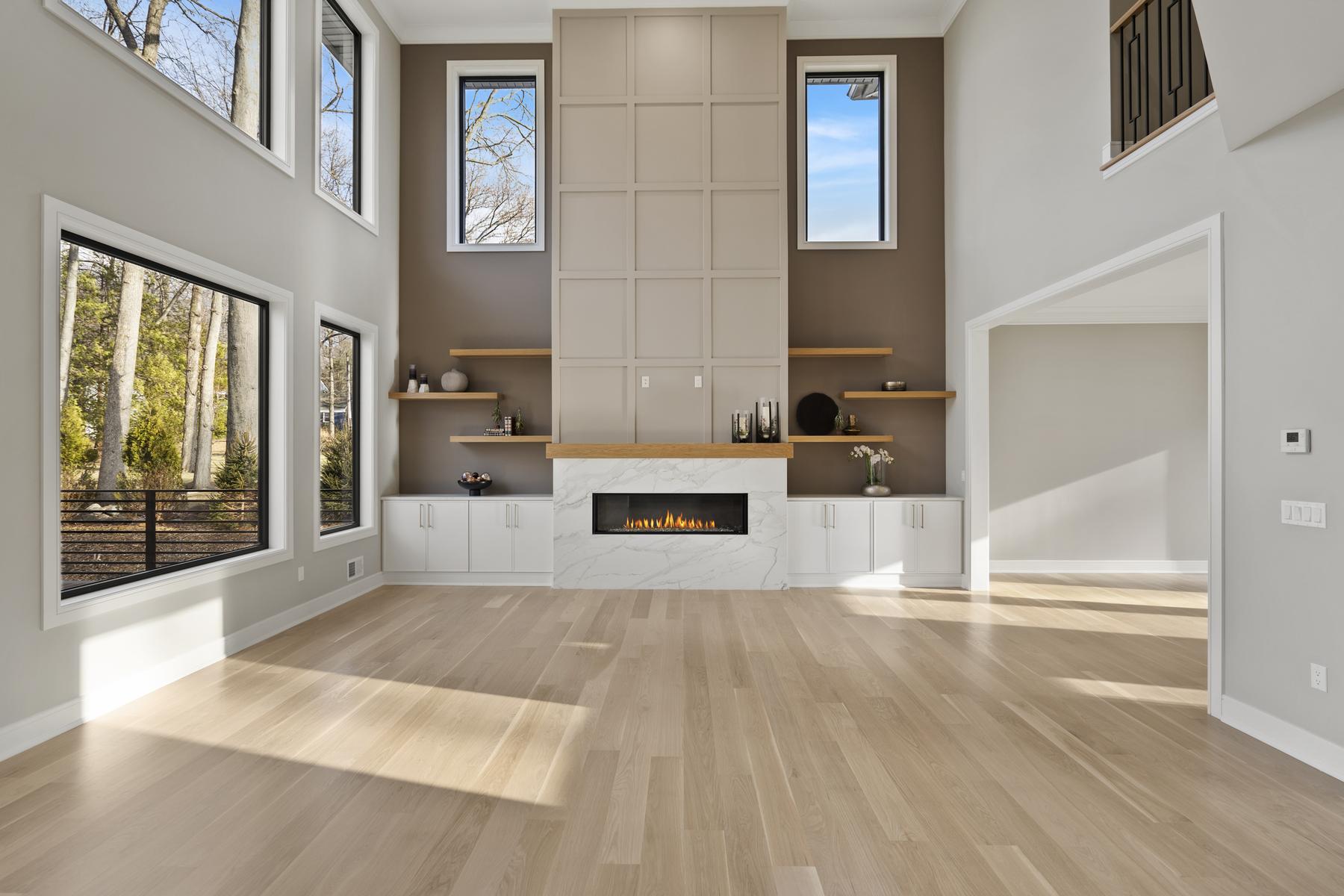 Two-story family room with a fireplace wall in a North Caldwell home built by MMC
